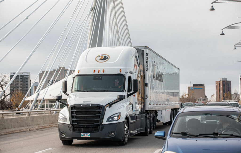 A Bison Transport truck on a bridge.