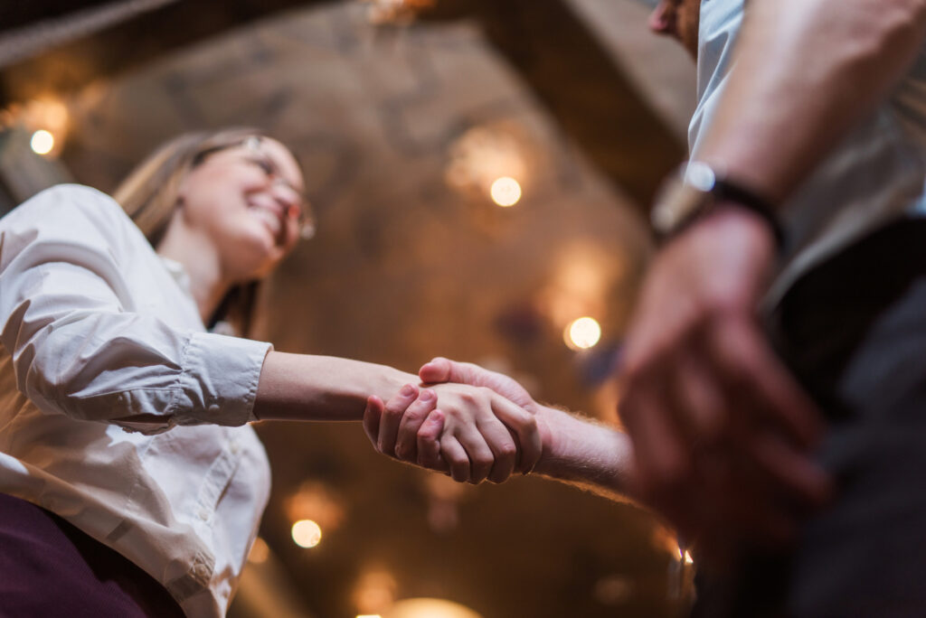 woman shaking man's hand