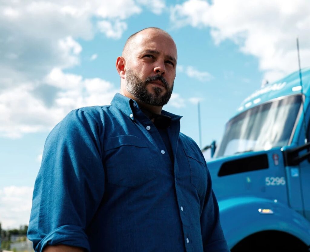 Man standing in front of Groupe Morneau truck 