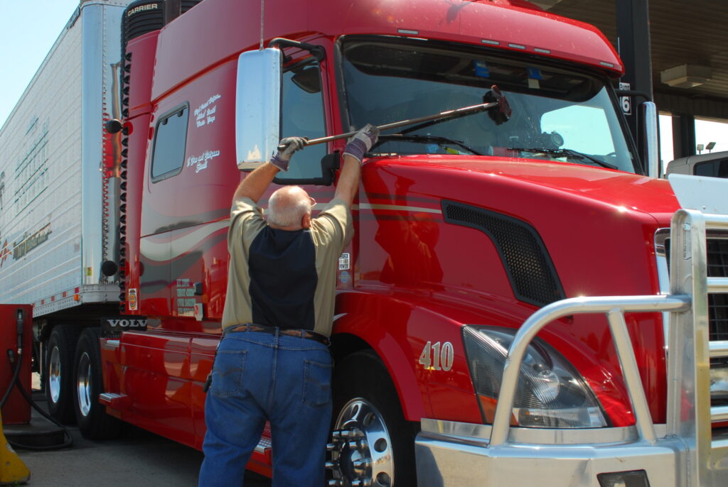 driver cleaning windshield